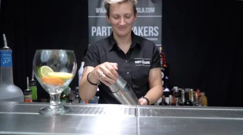 A female bartender holding a shaker | Flair Bartending for events | Bartender that can you do bar tricks