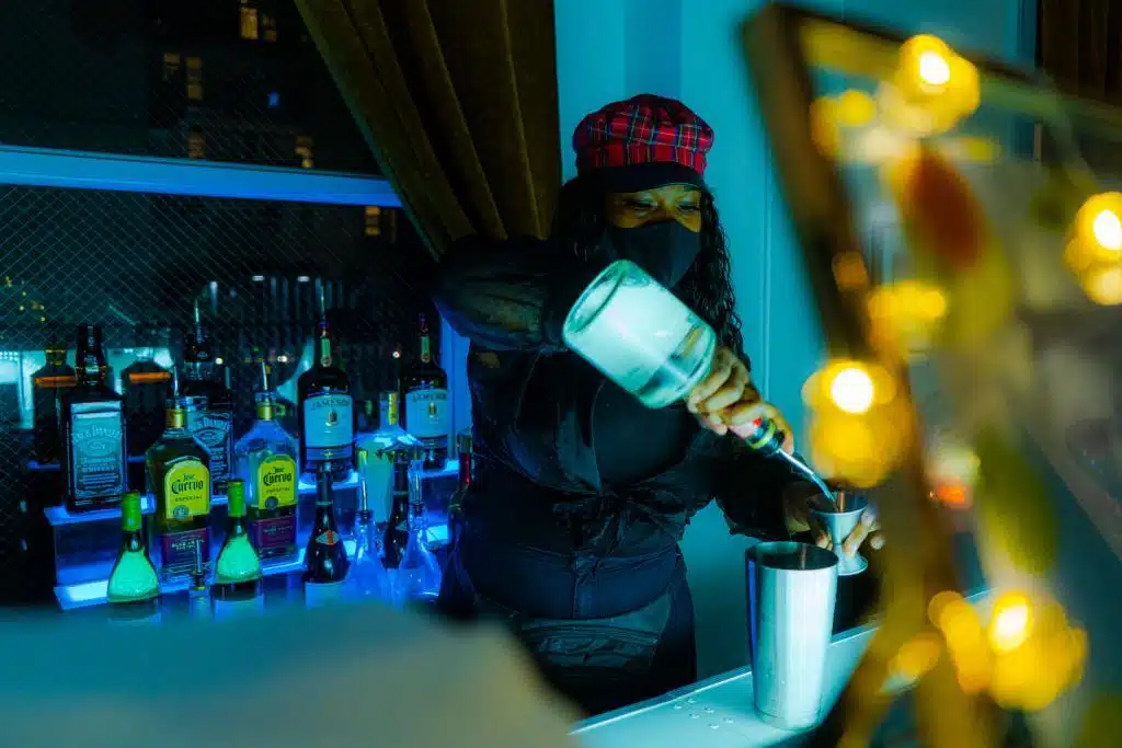 Bartender making a cocktail by party shakers
