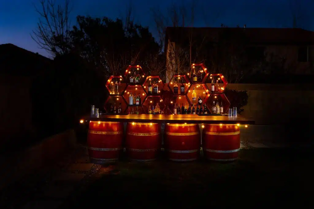 Extended Rustic Barrel Bars at night by Party Shakers